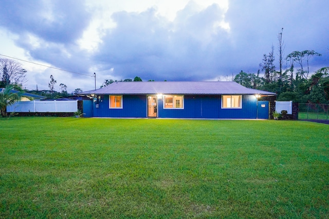 rear view of property featuring a yard