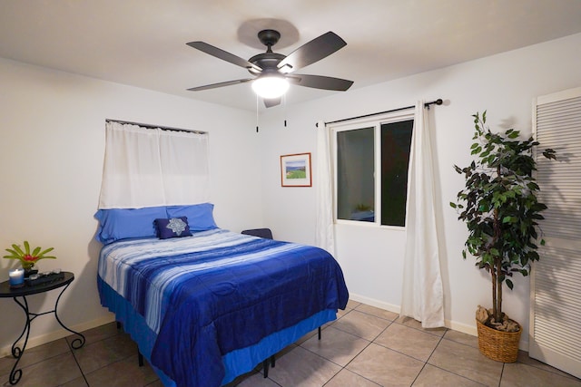 tiled bedroom with ceiling fan