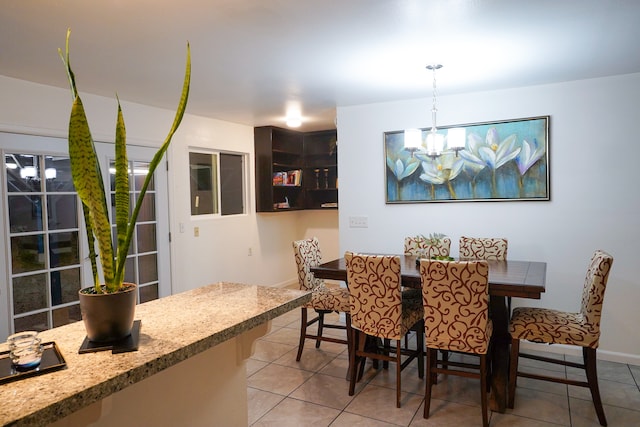 tiled dining area with a notable chandelier