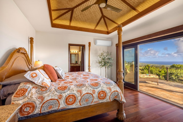 bedroom with access to outside, ensuite bath, ceiling fan, a wall mounted AC, and dark hardwood / wood-style flooring