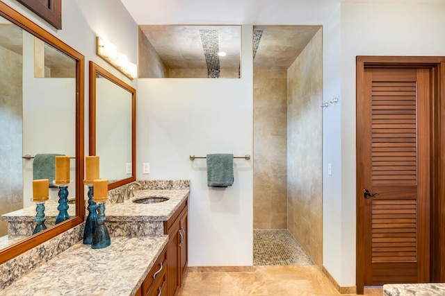 bathroom featuring vanity and a tile shower