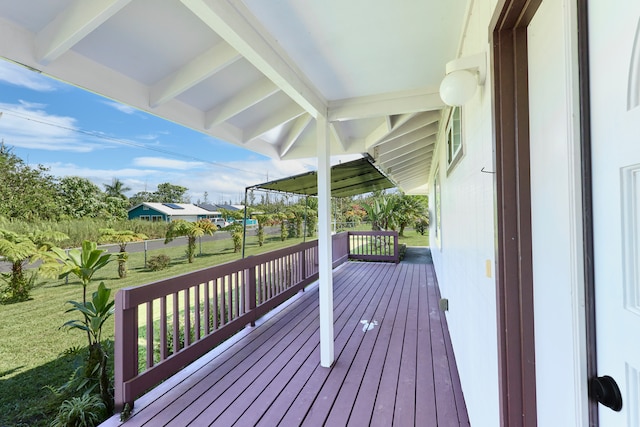 wooden terrace with a lawn