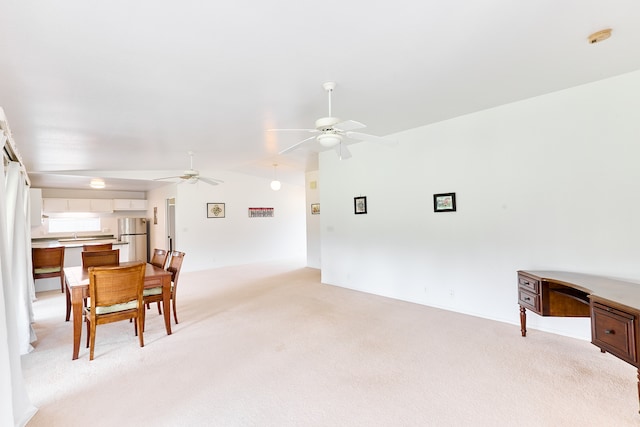 dining area featuring light carpet and ceiling fan