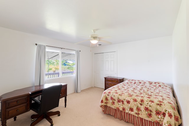 bedroom featuring ceiling fan, light colored carpet, and a closet