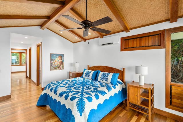 bedroom with hardwood / wood-style floors, vaulted ceiling with beams, a wall mounted AC, and ceiling fan