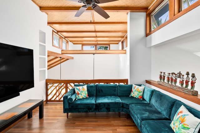 living room with beam ceiling, ceiling fan, plenty of natural light, and hardwood / wood-style flooring