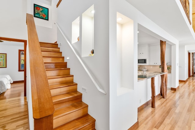 staircase with hardwood / wood-style floors