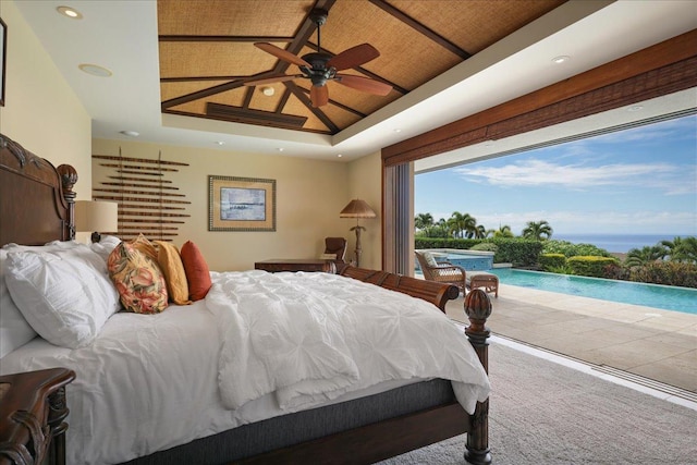 carpeted bedroom with access to exterior, a raised ceiling, and ceiling fan