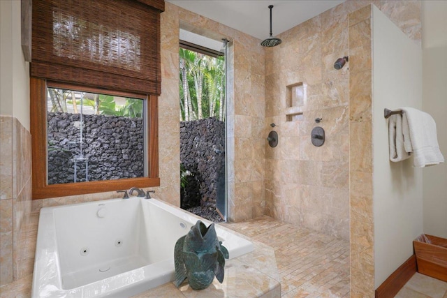 bathroom featuring plenty of natural light and plus walk in shower