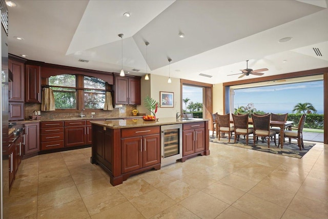 kitchen with ceiling fan, hanging light fixtures, tasteful backsplash, wine cooler, and lofted ceiling