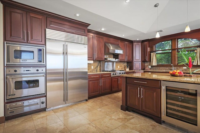 kitchen featuring light stone counters, ventilation hood, built in appliances, wine cooler, and lofted ceiling