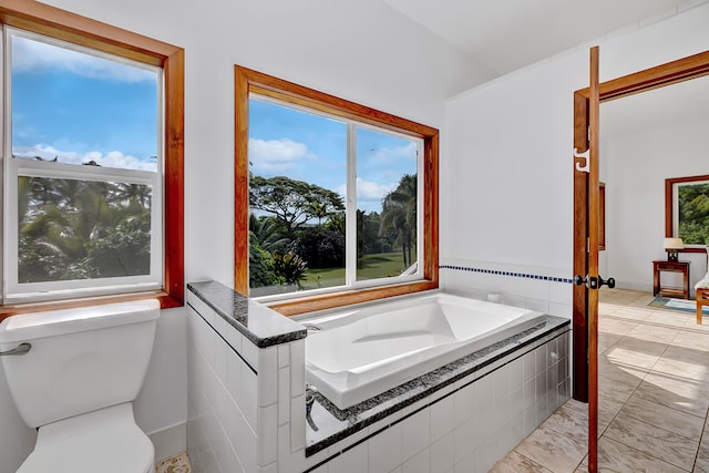 bathroom with a relaxing tiled tub