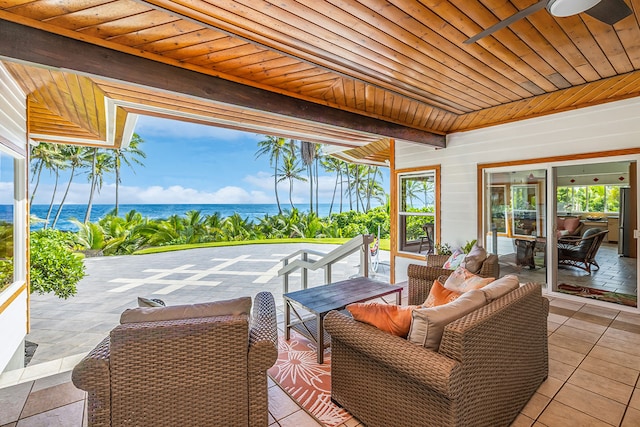 view of patio featuring outdoor lounge area, ceiling fan, and a water view