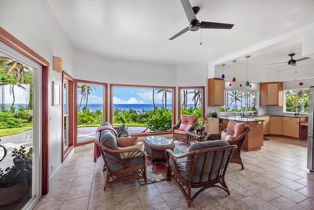 living room with a wealth of natural light and ceiling fan