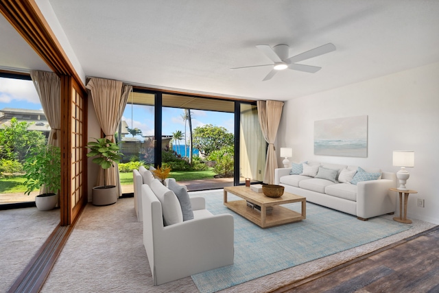 living room with hardwood / wood-style flooring, plenty of natural light, and ceiling fan