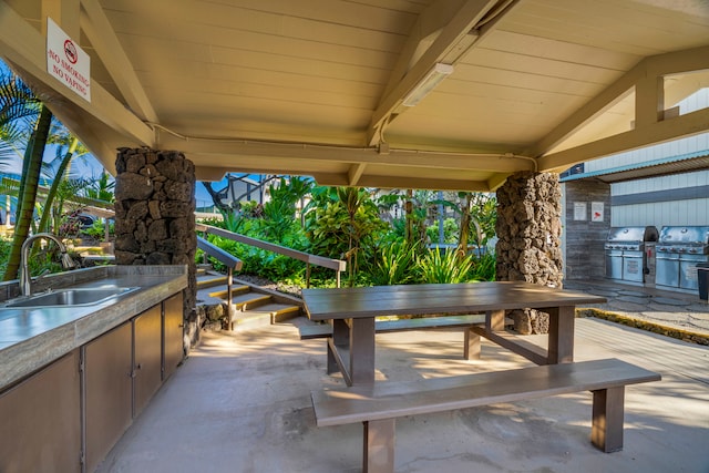 view of patio with area for grilling and sink