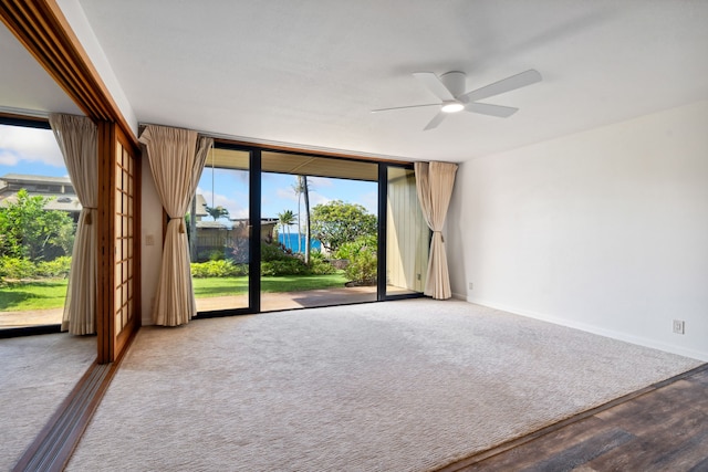 carpeted empty room featuring ceiling fan