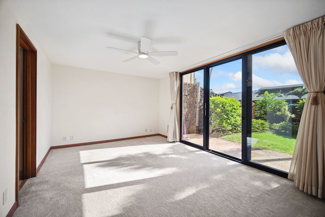 carpeted spare room with ceiling fan