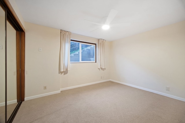 unfurnished bedroom with carpet, ceiling fan, and a closet