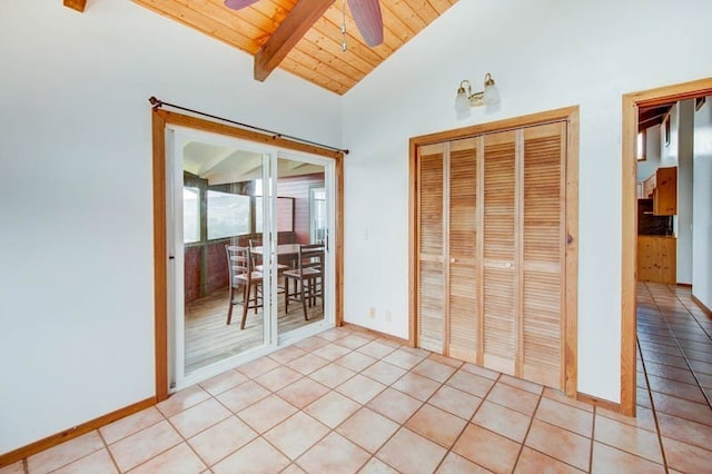 interior space featuring lofted ceiling with beams, a closet, light tile patterned floors, wood ceiling, and ceiling fan