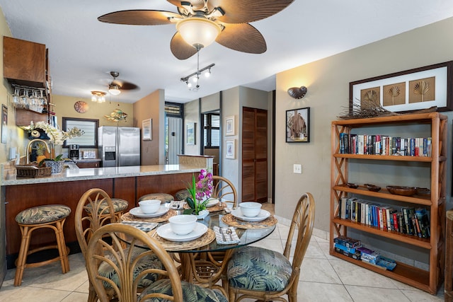 tiled dining room featuring ceiling fan