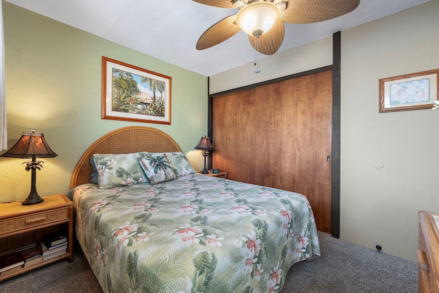 carpeted bedroom featuring ceiling fan and a closet