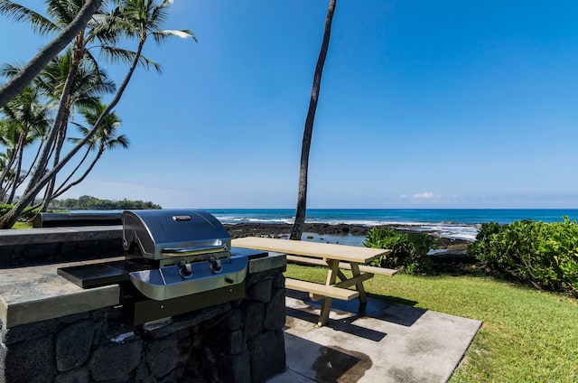 view of patio / terrace featuring a beach view and a water view