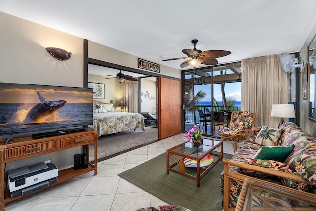 bedroom featuring access to exterior, light tile patterned floors, and ceiling fan