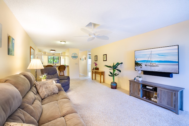 carpeted living room featuring ceiling fan