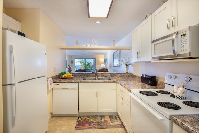 kitchen with white cabinetry, white appliances, and sink