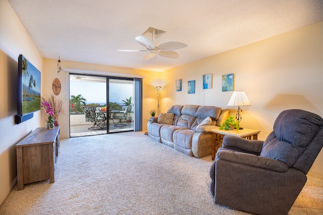 living room with carpet flooring, a textured ceiling, and ceiling fan