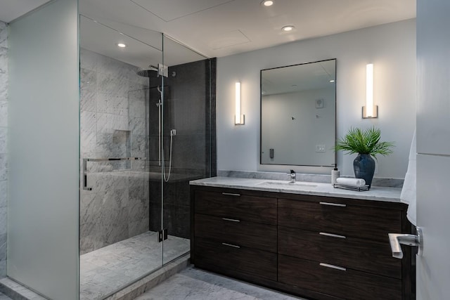 bathroom with vanity and a shower with shower door