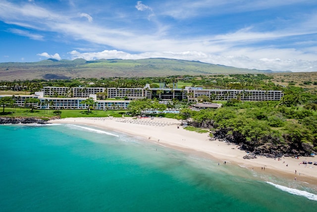 aerial view with a water and mountain view and a beach view