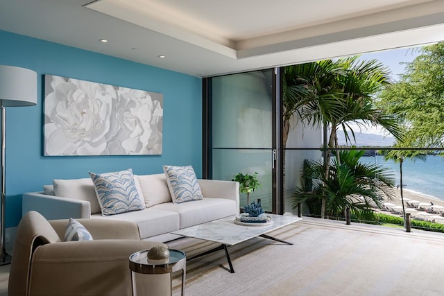 living room featuring a water view and plenty of natural light