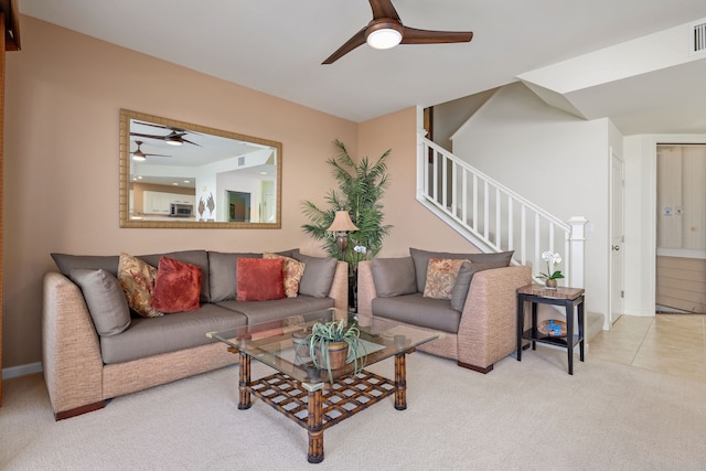 carpeted living room with ceiling fan