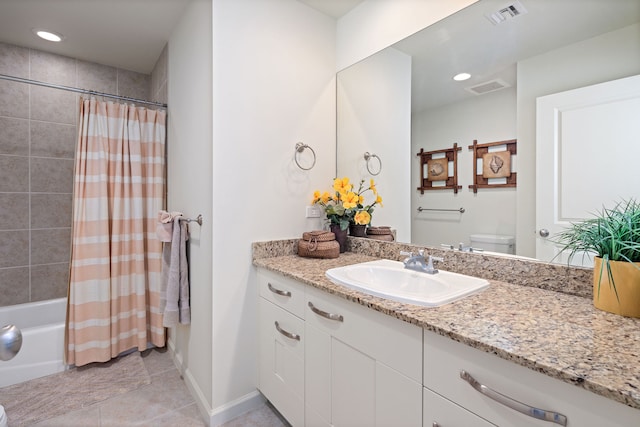 full bathroom featuring tile patterned floors, vanity, toilet, and shower / tub combo with curtain