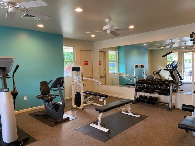 gym with ceiling fan and a healthy amount of sunlight