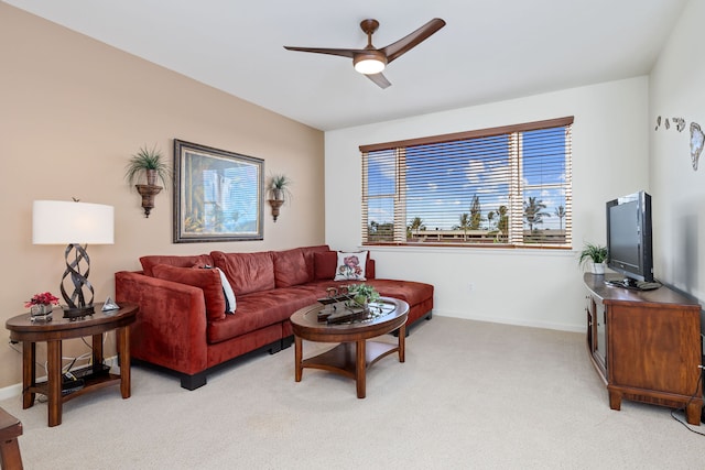 carpeted living room with ceiling fan