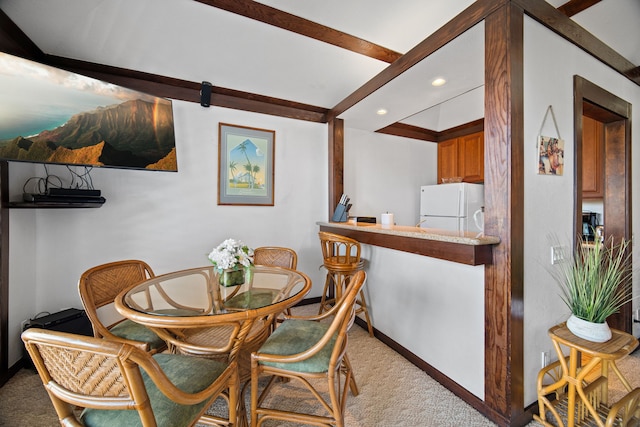 carpeted dining room with a barn door