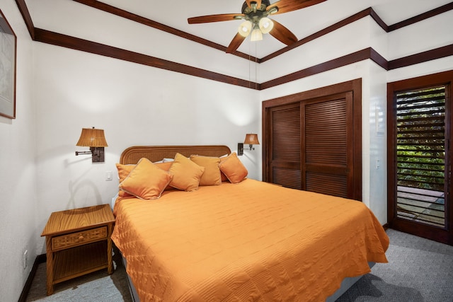 carpeted bedroom featuring ceiling fan, a closet, and ornamental molding