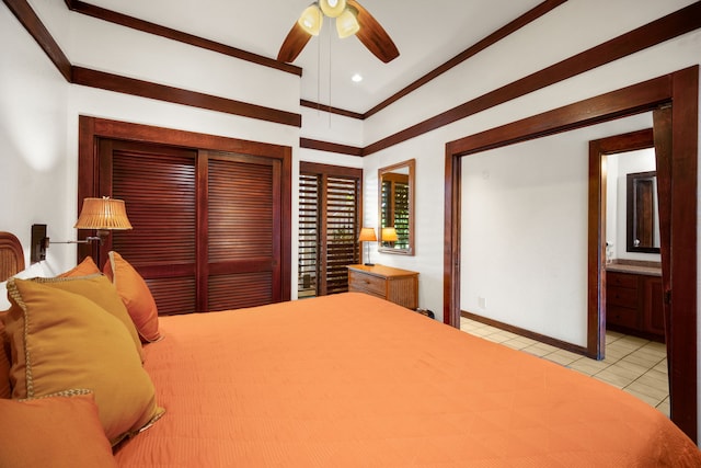 bedroom featuring connected bathroom, ceiling fan, and light tile patterned floors