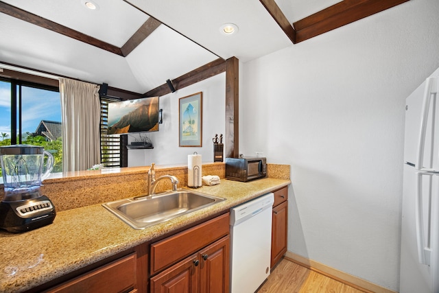 kitchen featuring light wood-type flooring, white appliances, and sink