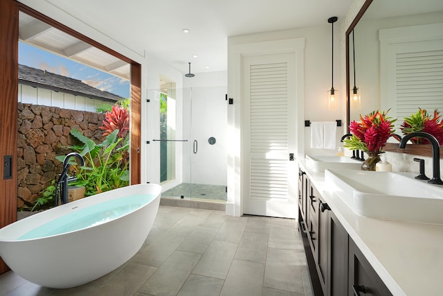 bathroom featuring tile patterned floors, vanity, and independent shower and bath