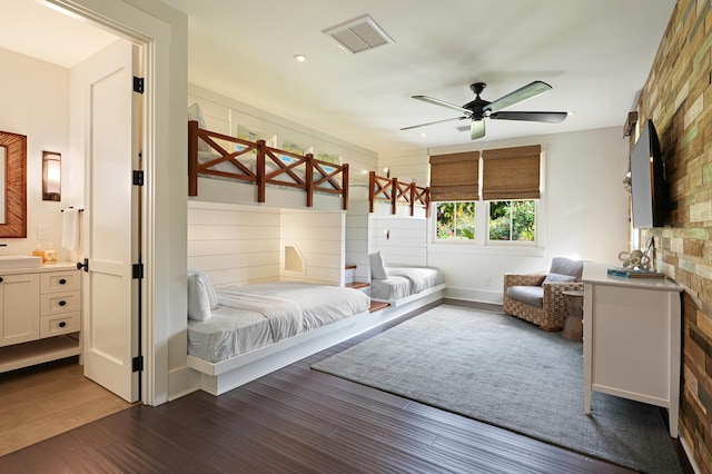 bedroom with ceiling fan, sink, and dark wood-type flooring