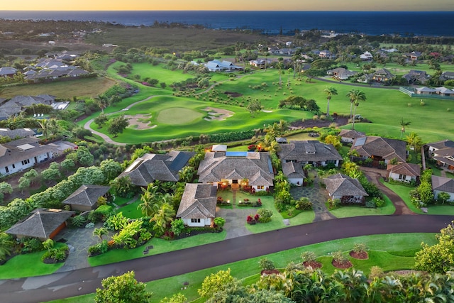 aerial view at dusk featuring a water view