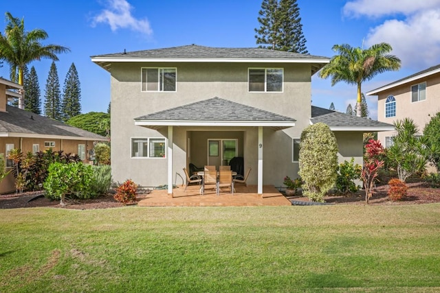 rear view of house featuring a patio area and a yard
