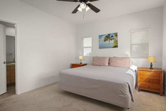 carpeted bedroom featuring ceiling fan and connected bathroom
