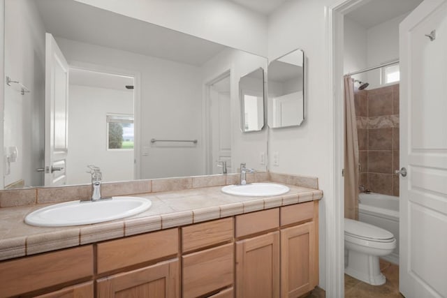 full bathroom featuring vanity, shower / tub combo, and toilet