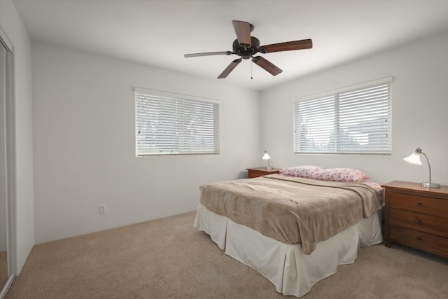 bedroom with light carpet and ceiling fan