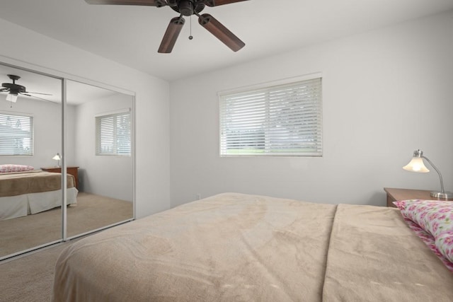 carpeted bedroom with a closet and ceiling fan